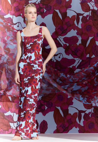 Woman wearing red floral printed stretch knit long dress by designer Ala von Auersperg for womens luxury travel clothing