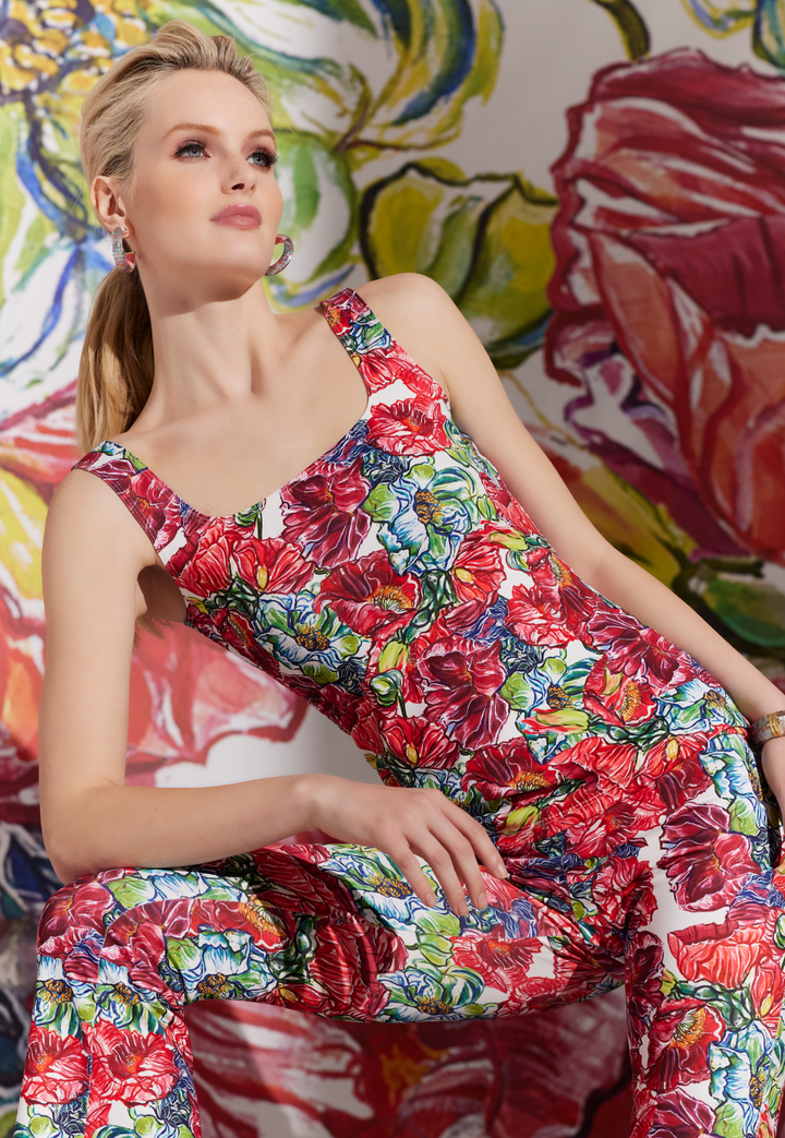 Woman wearing stretch knit tank top with matching pants in a red floral print by designer Ala von Auersperg for womens luxury travel clothing