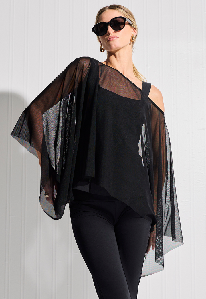 Woman wearing short mesh top in black over matching cotton black tank top and pants with sunglasses by designer Ala von Auersperg for womens luxury travel clothing