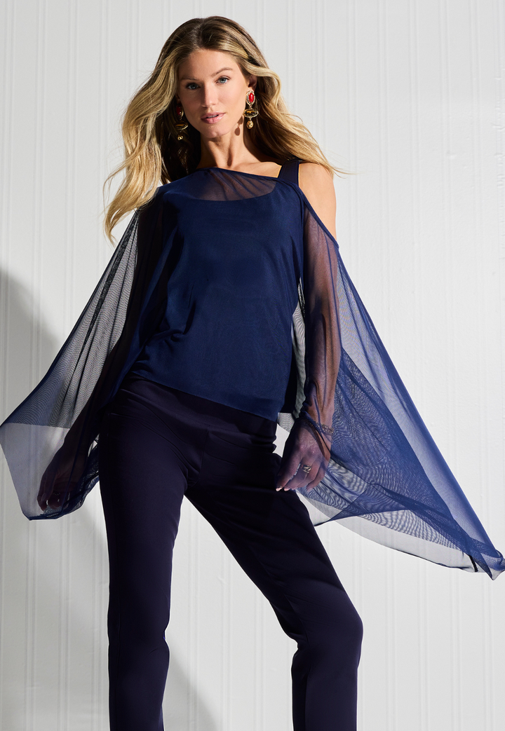 Woman wearing sheer mesh poncho over matching cotton tank top and pants in Navy by designer Ala von Auersperg for womens luxury travel clothing
