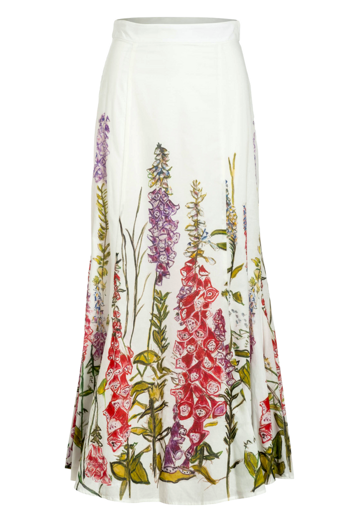 Flat image of a white cotton skirt with a floral printed trim by designer Ala von Auersperg for womens luxury travel clothing