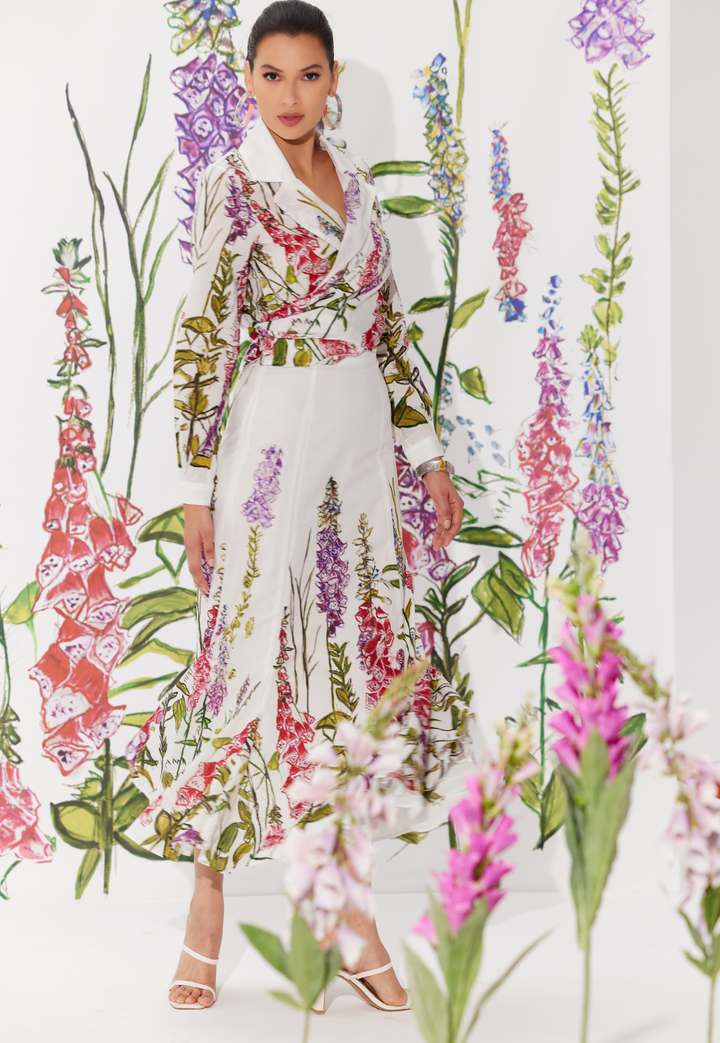 Woman wearing cotton skirt with matching wrap top in a white floral print by designer Ala von Auersperg for womens luxury travel clothing