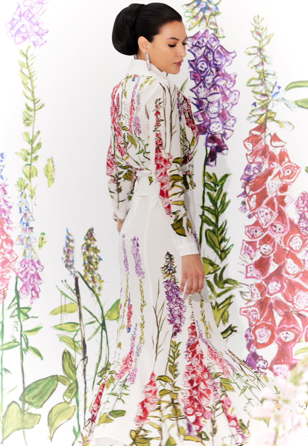 Woman wearing cotton skirt and wrap top in a matching white floral print by designer Ala von Auersperg for womens luxury travel clothing