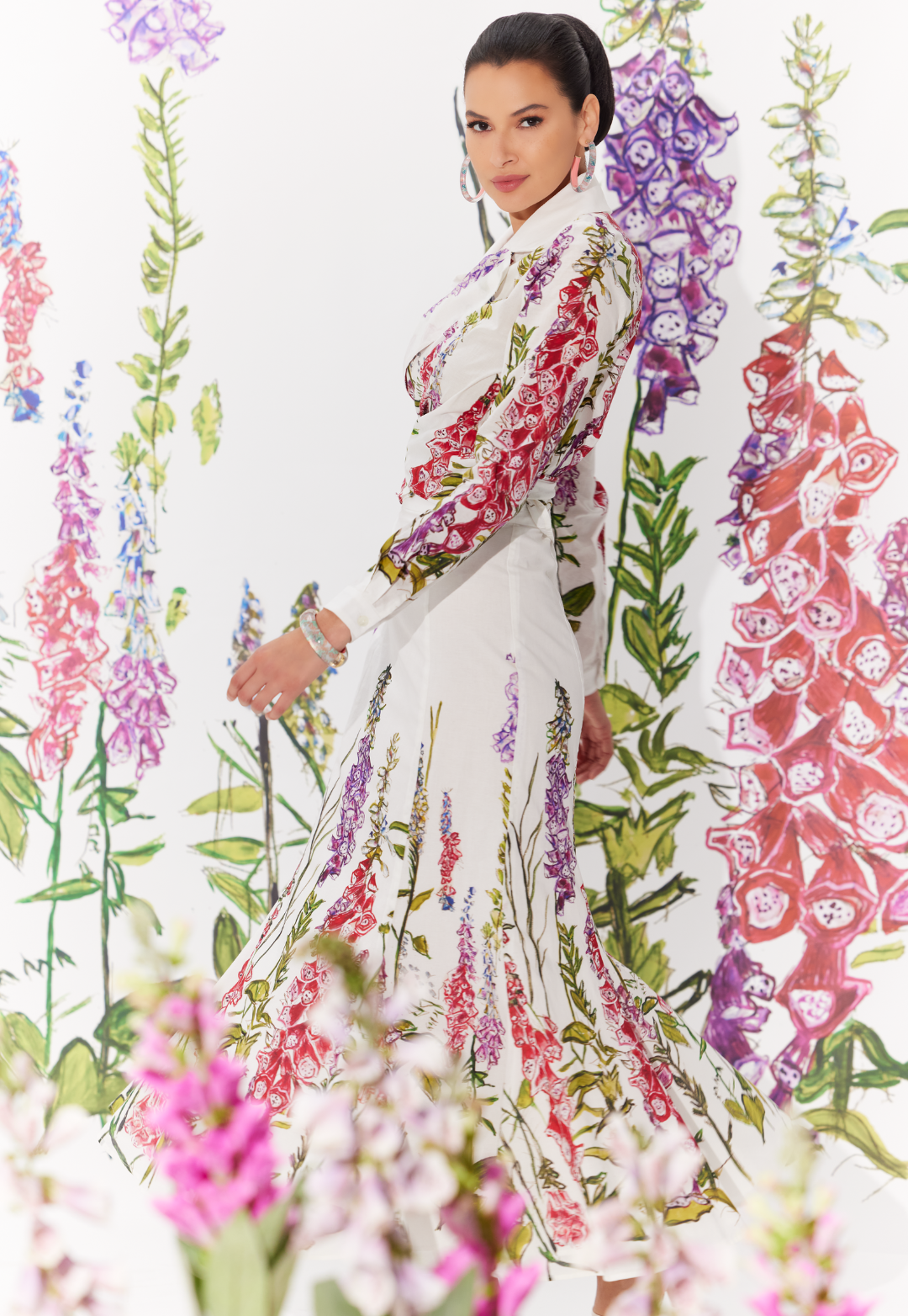 Woman wearing matching cotton skirt and wrap top in a white floral print by designer Ala von Auersperg for womens luxury travel clothing