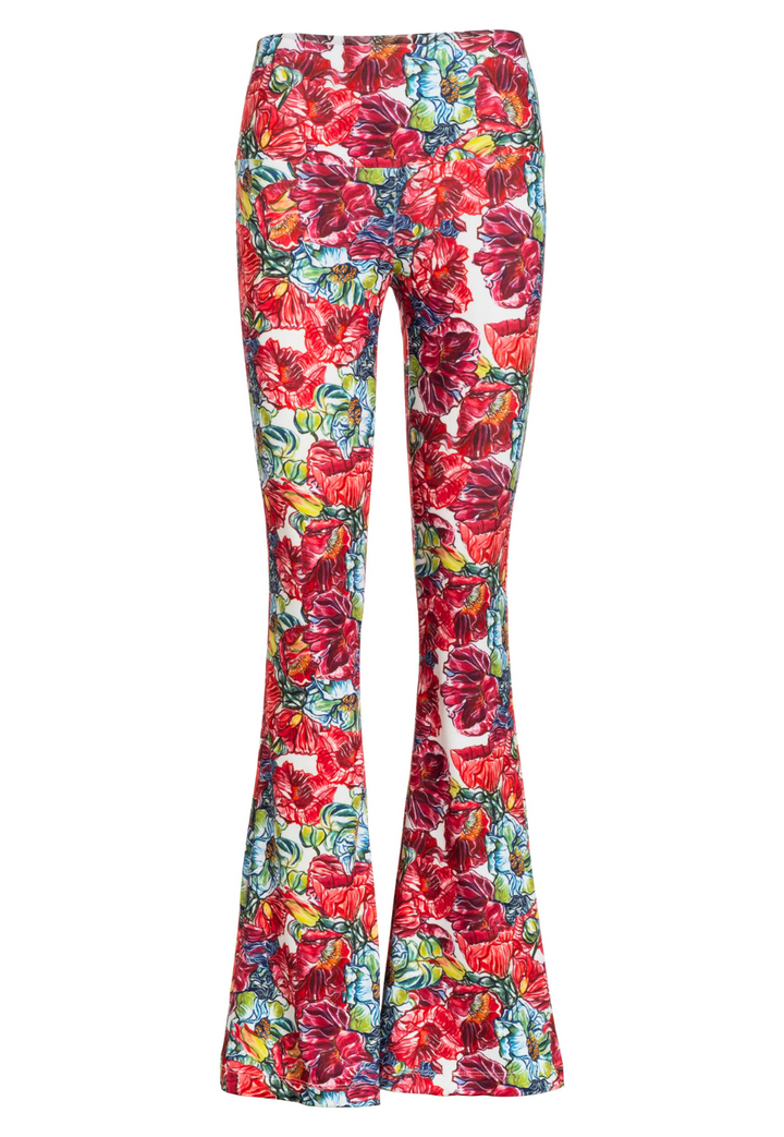 Image of a stretch knit pant in a red floral print by designer Ala von Auersperg for womens luxury travel clothing