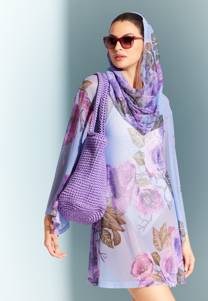 Woman wearing sheer hoodie cover up over a swimsuit with a purple crochet bucket bag by designer Ala von Auersperg for womens luxury travel clothing