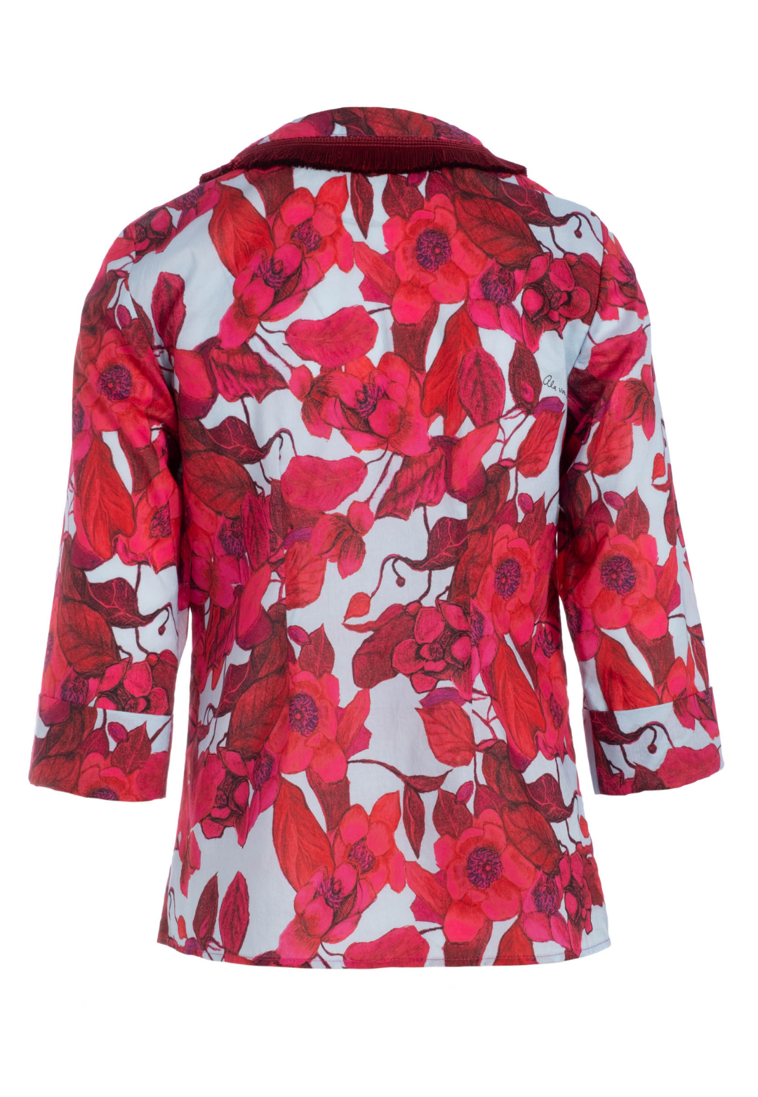 Flat image of a cotton tunic with a italian fringe trim in a red floral print by designer Ala von Auersperg for womens luxury travel clothing