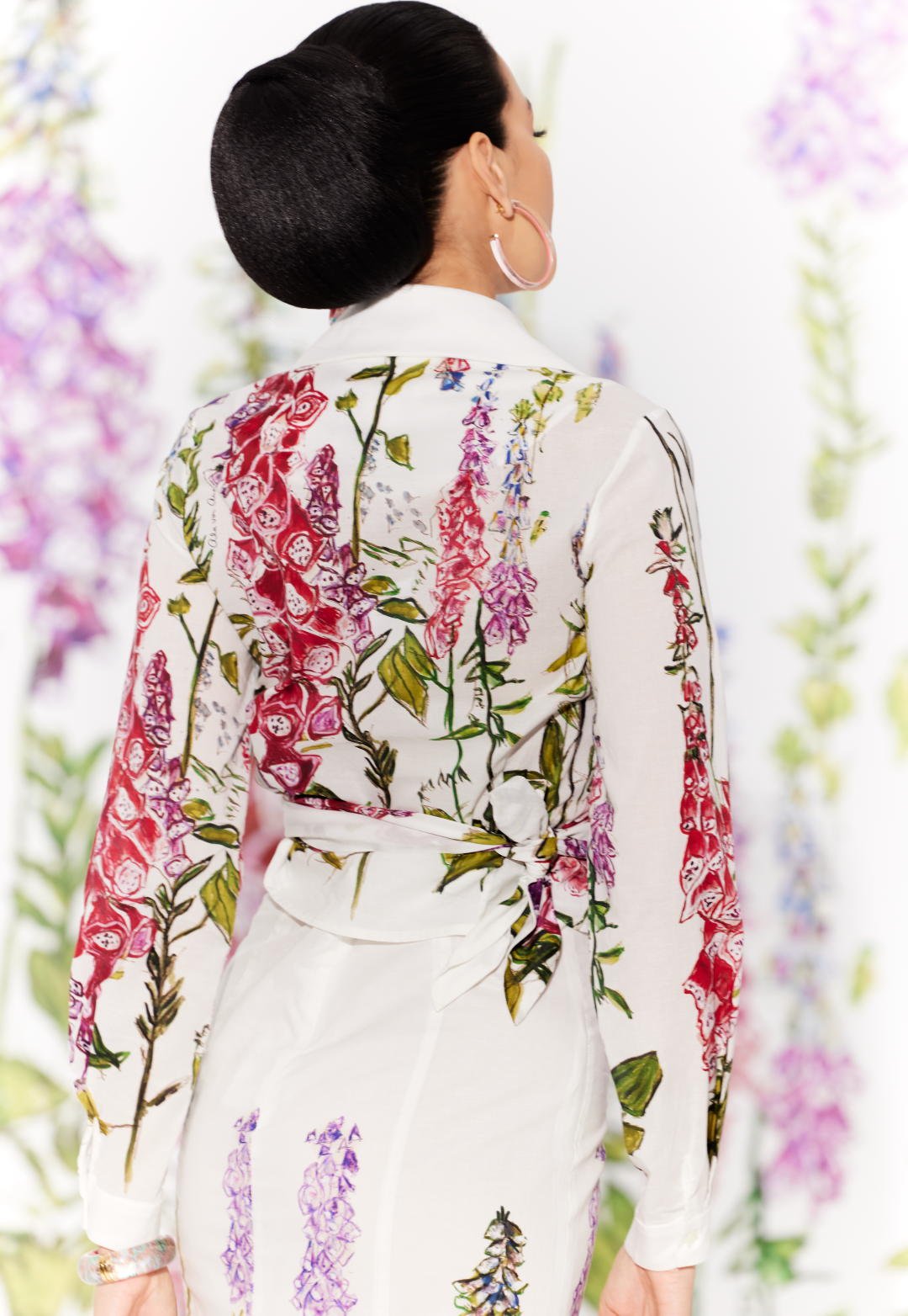 Woman wearing cotton wrap top in a white floral print with a matching skirt by designer Ala von Auersperg for womens luxury travel clothing