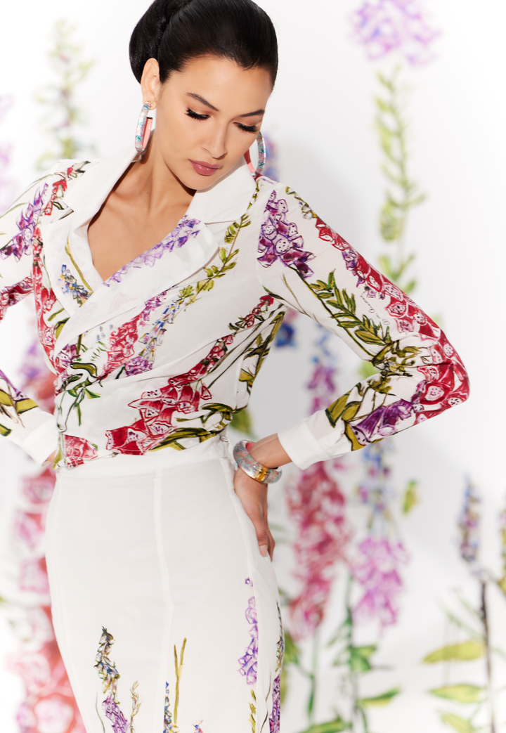 Woman wearing cotton wrap top in a white floral print with a matching skirt by designer Ala von Auersperg for womens luxury travel clothing