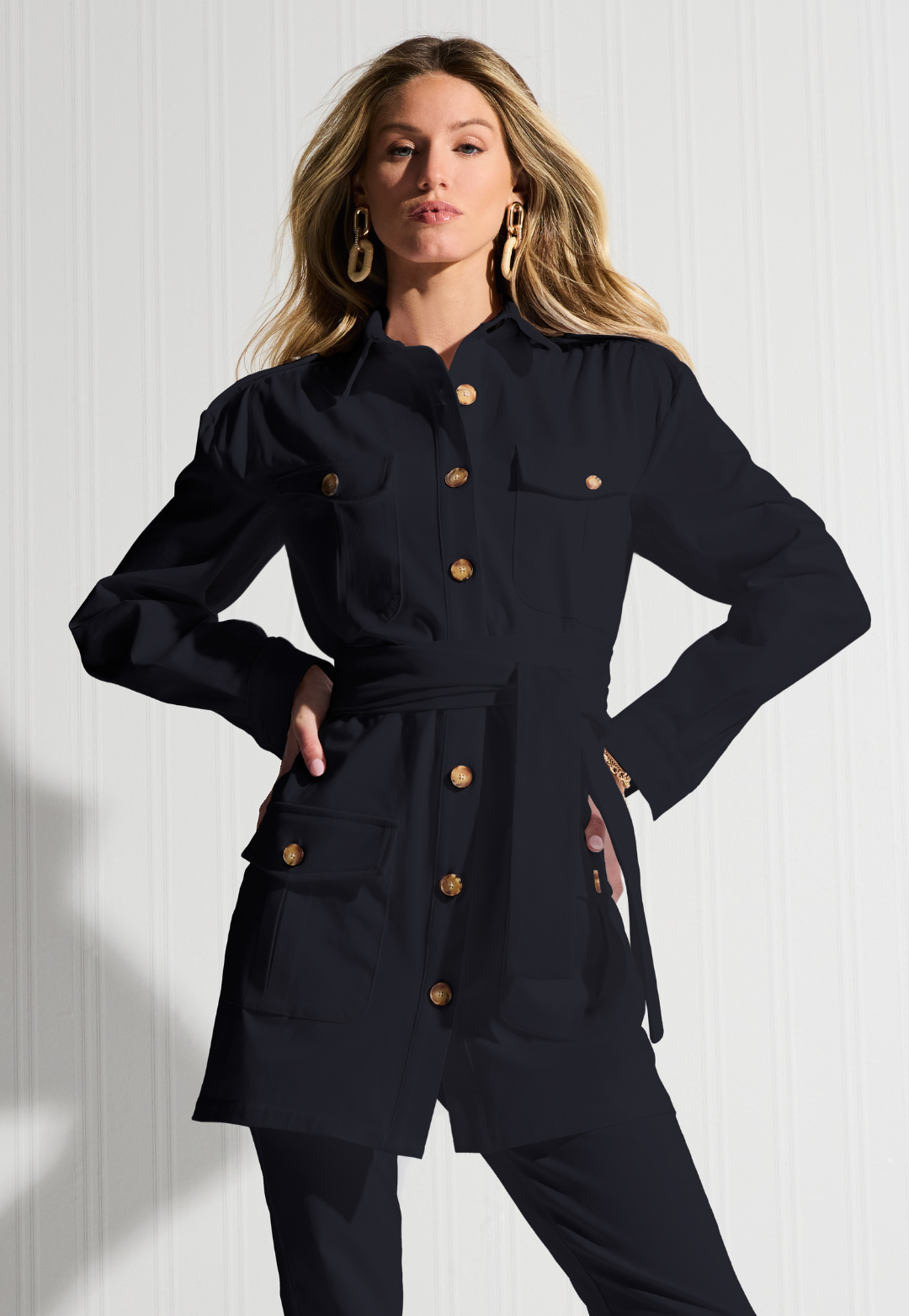 Woman wearing a black cotton safari jacket by designer Ala von Auersperg for womens luxury travel clothing