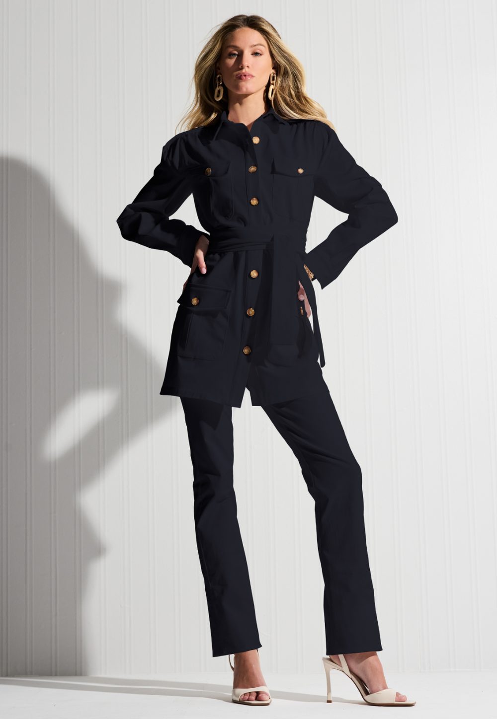 Woman wearing a black cotton safari jacket with black cotton pants by designer Ala von Auersperg for womens luxury travel clothing