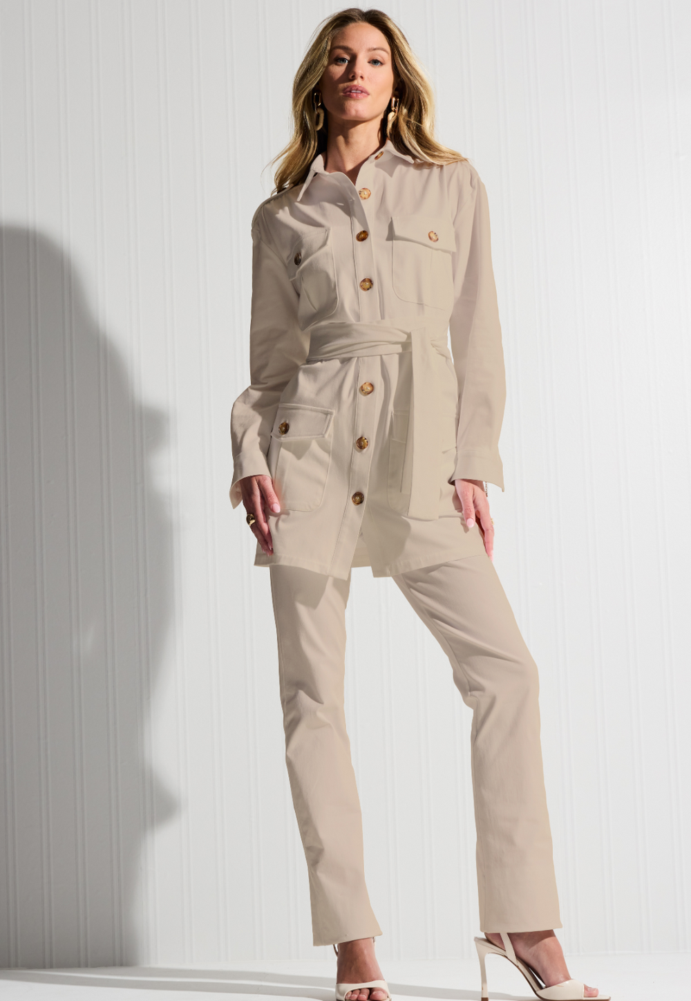 Woman wearing khaki cotton safari jacket with cotton khaki pants by designer Ala von Auersperg for womens luxury travel clothing