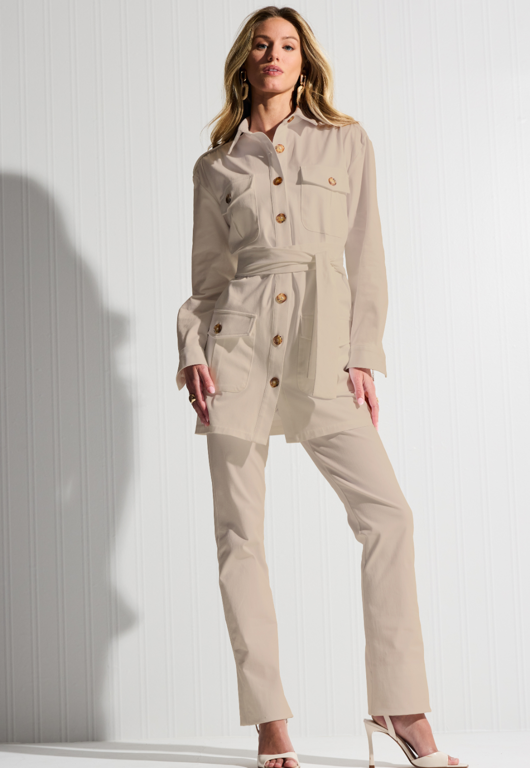 Woman wearing khaki cotton safari jacket with cotton khaki pants by designer Ala von Auersperg for womens luxury travel clothing