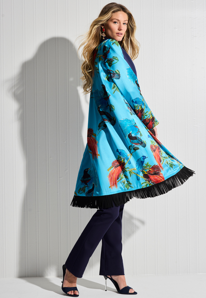 Woman wearing silk bird printed reversible jacket over cotton navy pants by designer Ala von Auersperg for womens luxury travel clothing