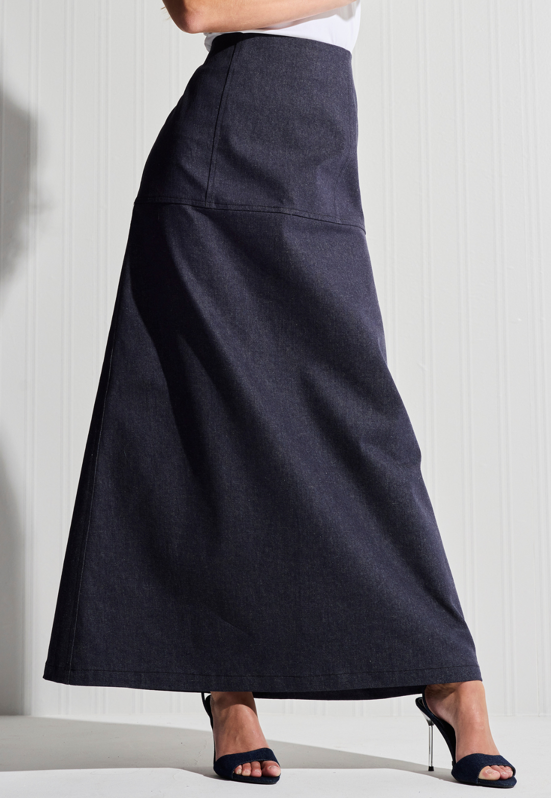 Woman wearing long denim skirt by designer Ala von Auersperg  for womens luxury travel clothing