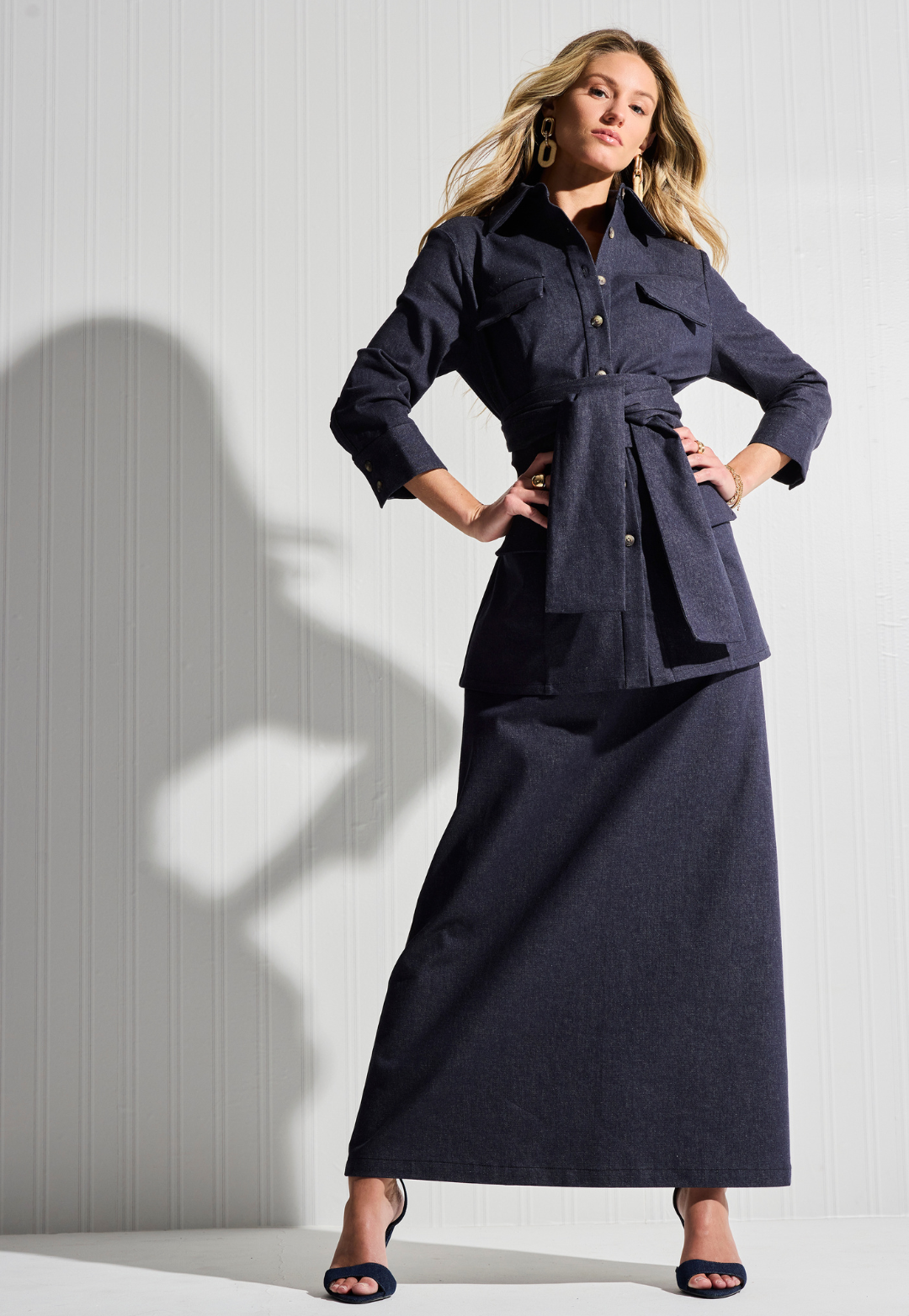 Woman wearing denim jacket and skirt by designer Ala von Auersperg for womens luxury travel clothing