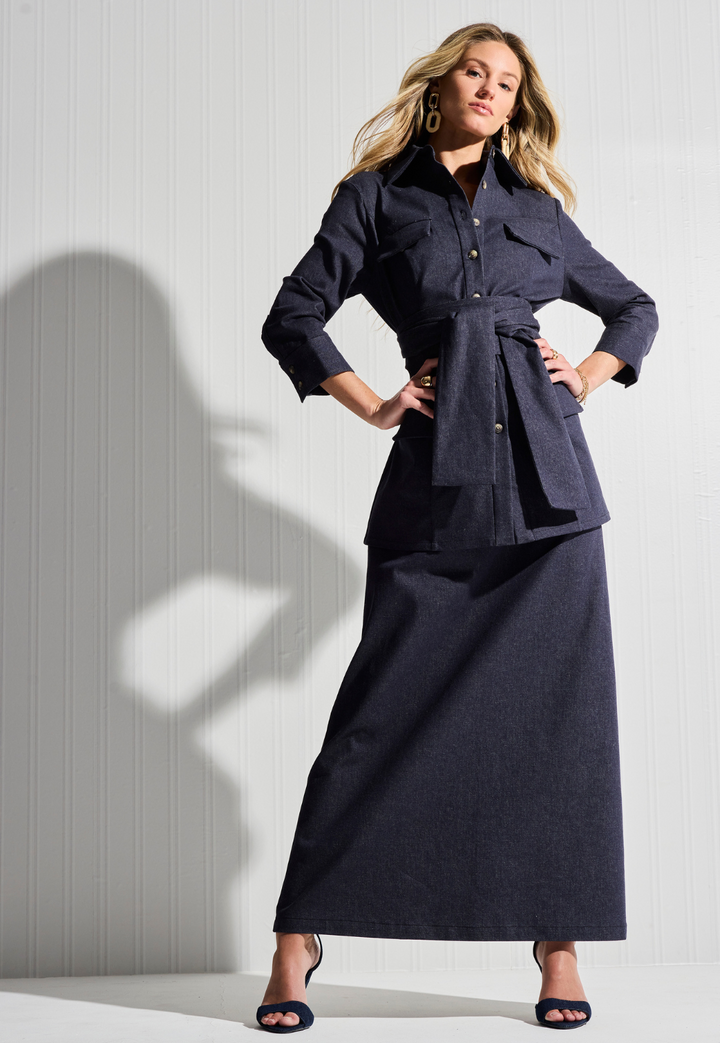 Woman wearing denim jacket and skirt by designer Ala von Auersperg for womens luxury travel clothing