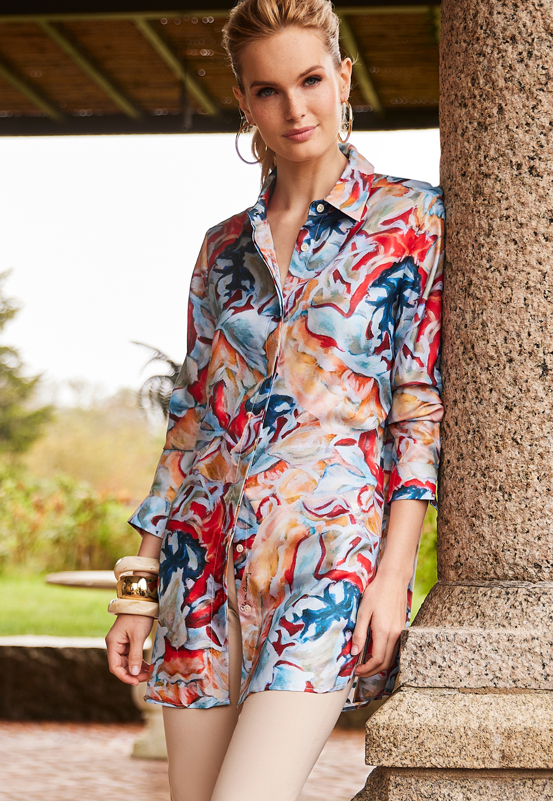Woman wearing Ala Koi colorful printed silk blouse with khaki pants