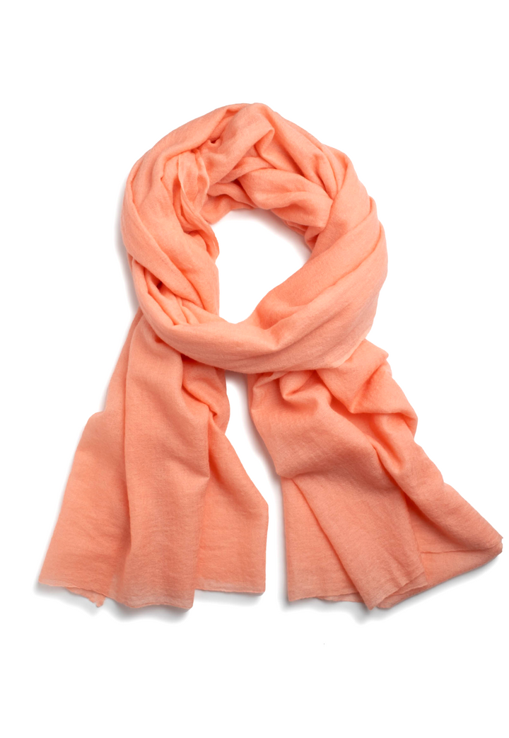 Apricot lightweight cashmere scarf wrapped around the neck