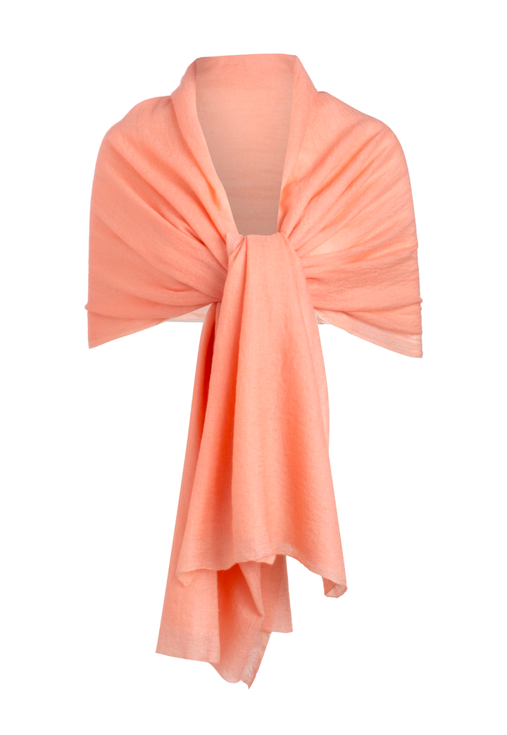 Apricot peach cashmere shawl styled over the shoulders with a front tie