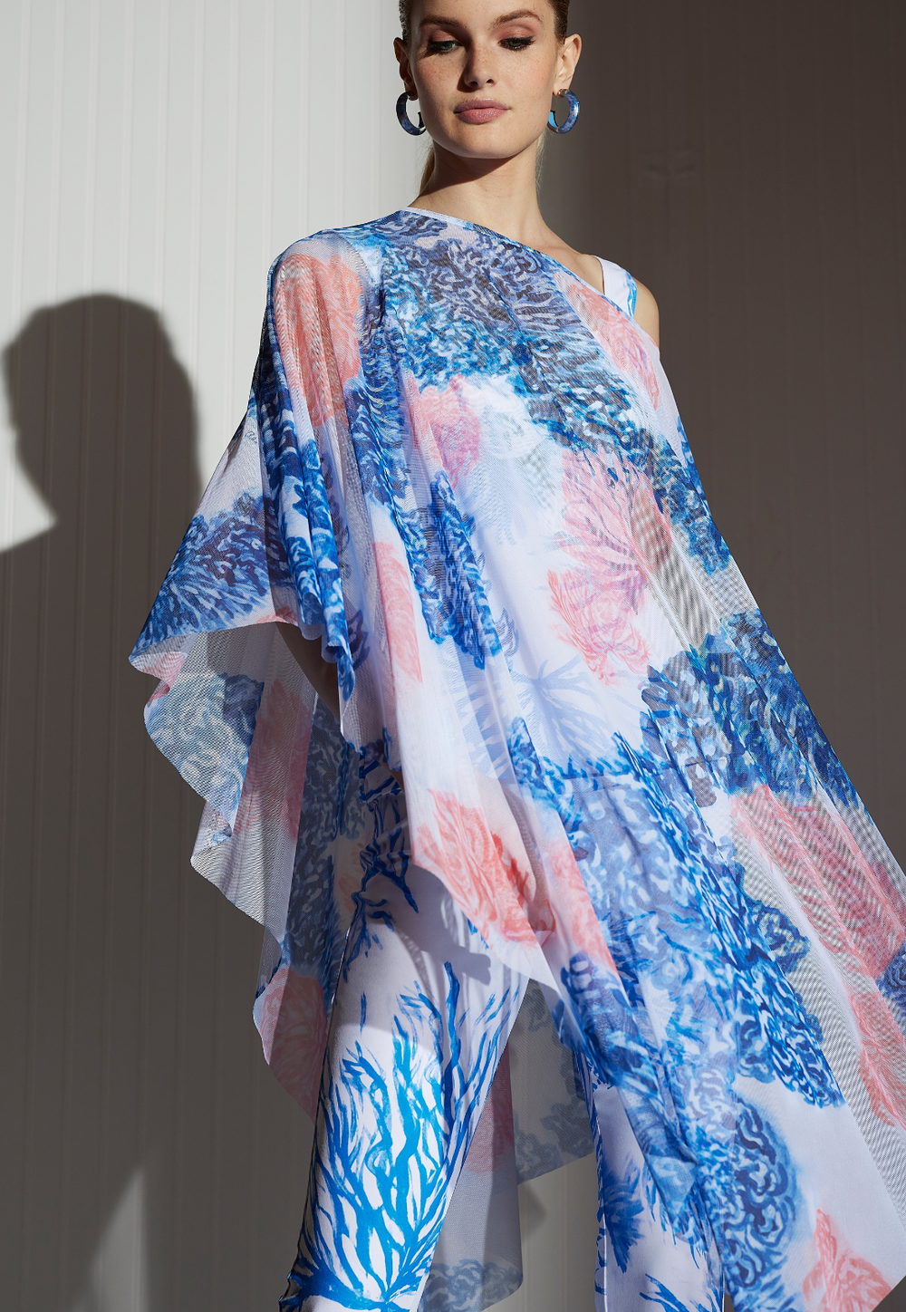 Artemisia Coral Reef sheer mesh poncho styled with matching printed pants and coral earrings