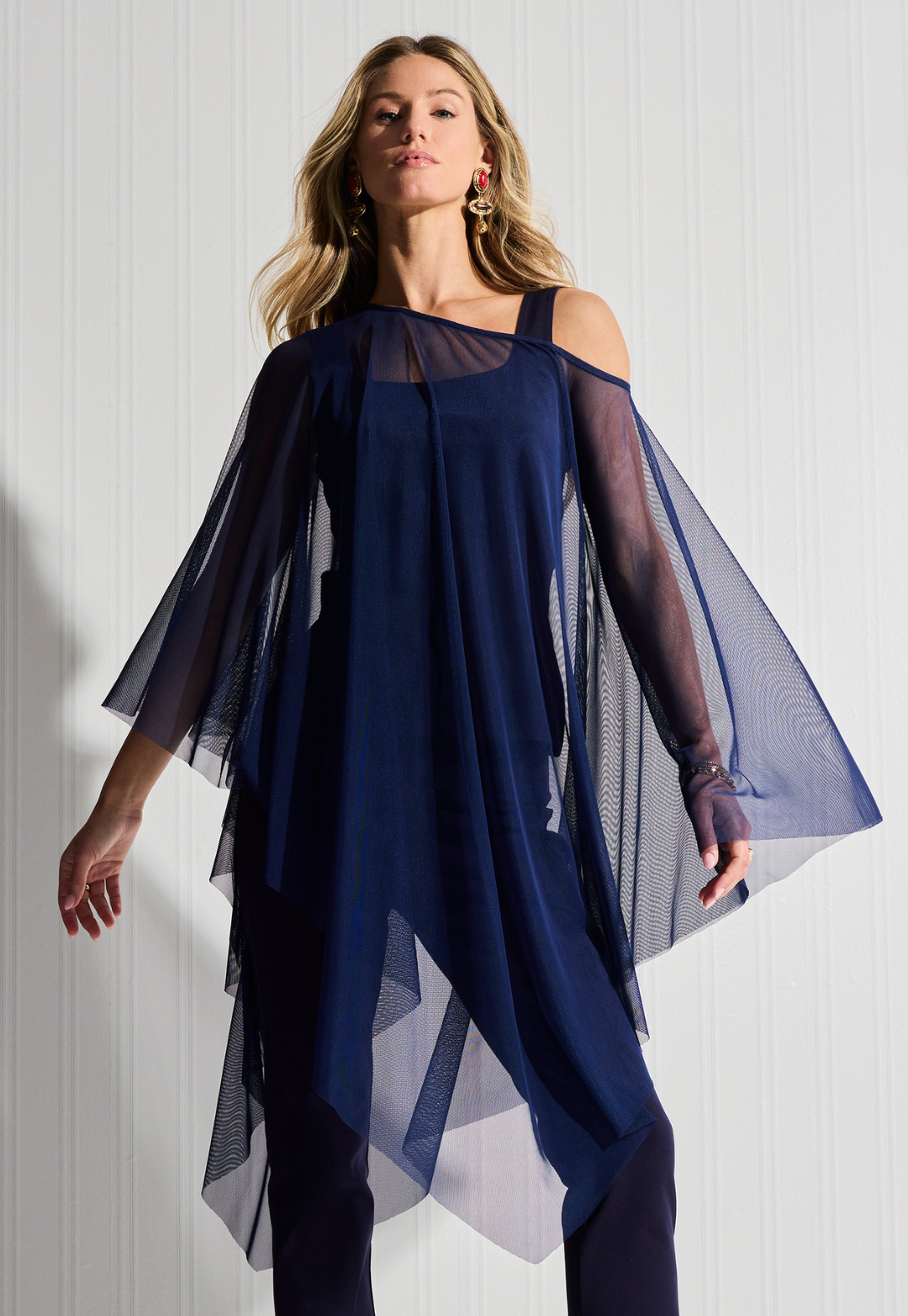 Woman wearing Artemisia navy sheer mesh poncho over matching tank and pants