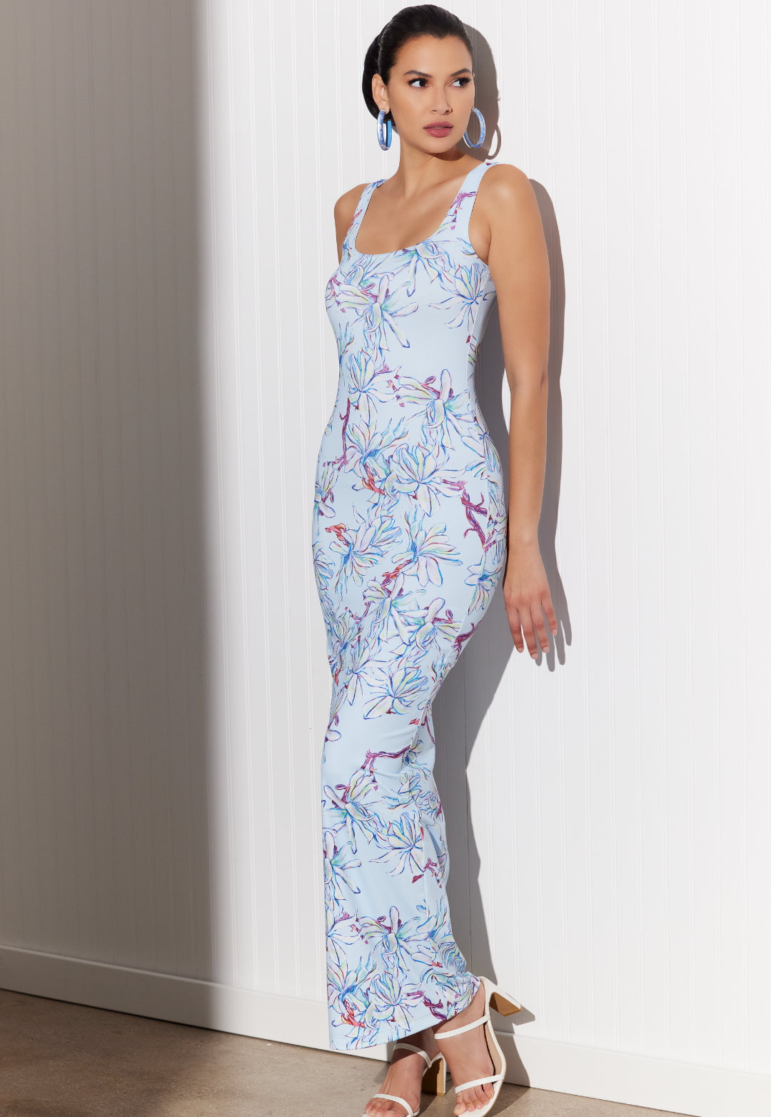 Woman wearing Caterina Magnolia blue floral stretch knit maxi dress