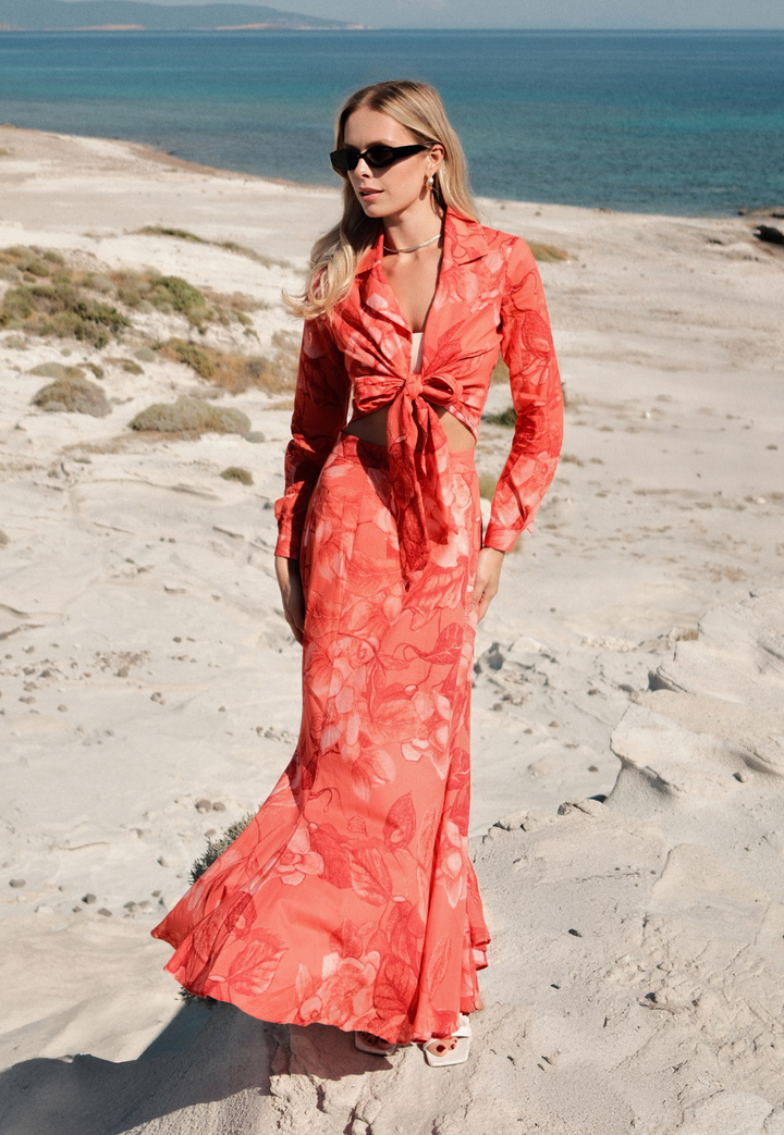 Woman wearing Crawford bright red floral cotton skirt on the beach