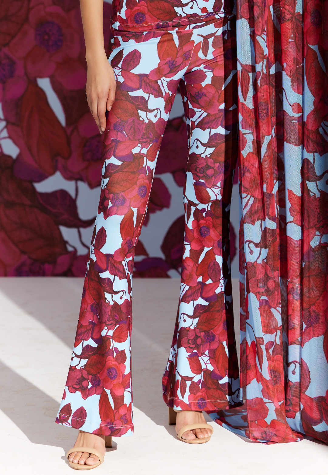 Woman wearing Elaine Raspberry Grandiflora stretch knit flare pants