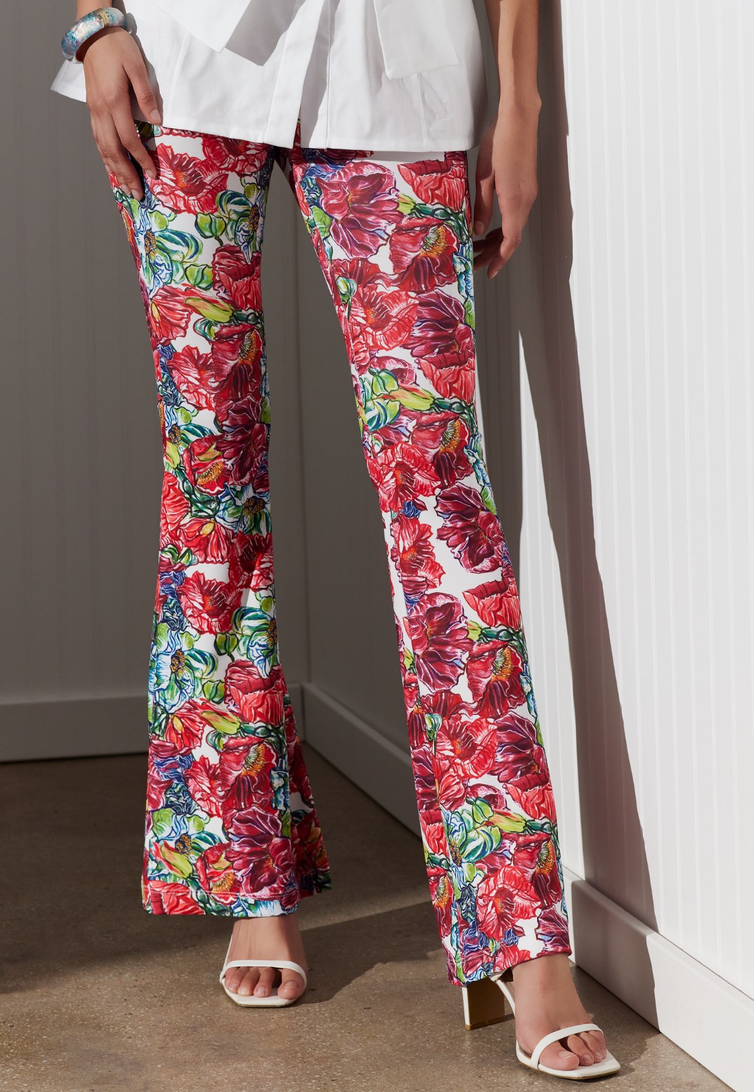 Woman wearing Elaine red floral stretch knit flare pants