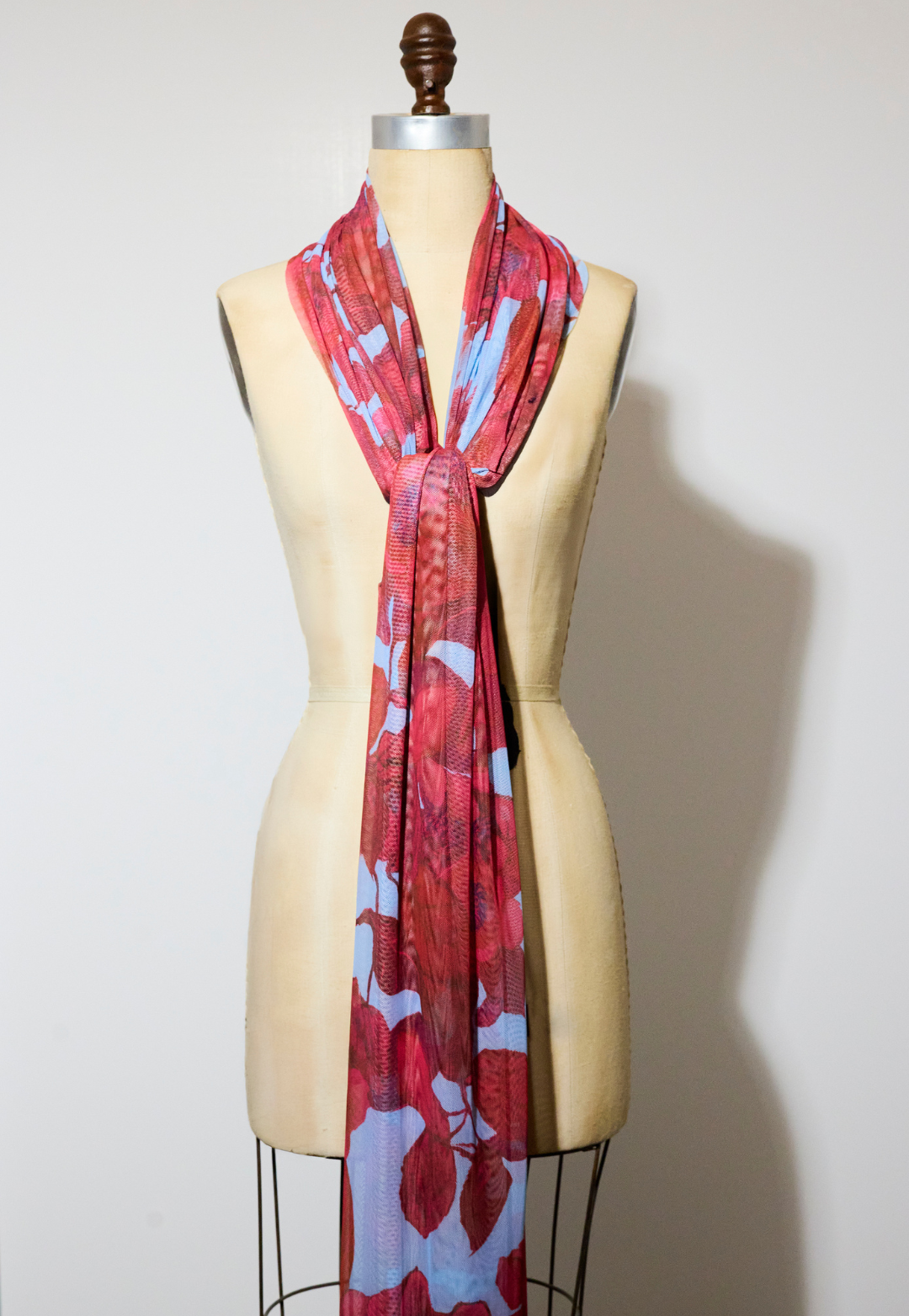 Woman wearing Gala Raspberry Grandiflora sheer mesh wrap