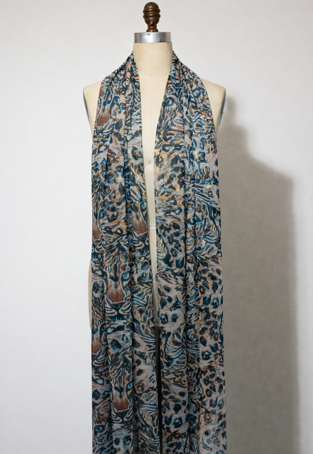 Gala sheer mesh wrap in Snow Leopard draped on mannequin