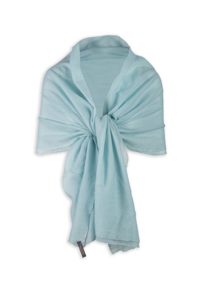 Illusion Blue cashmere wrap draped over the shoulders and tied at the front