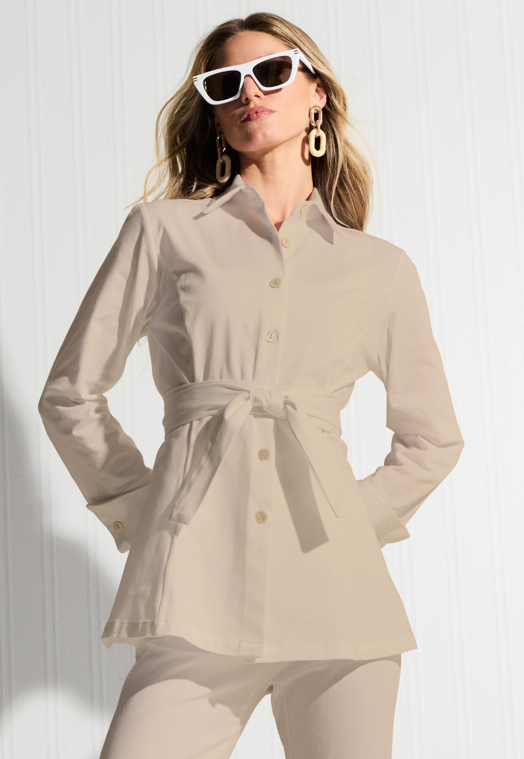 Woman wearing Keaton khaki Italian stretch cotton blouse with self-tie belt and sunglasses
