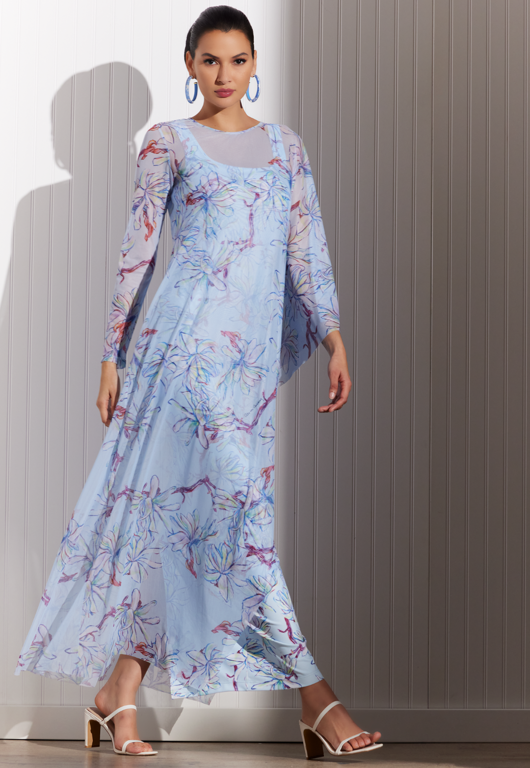Woman wearing Magnolia sheer poncho over blue floral dress