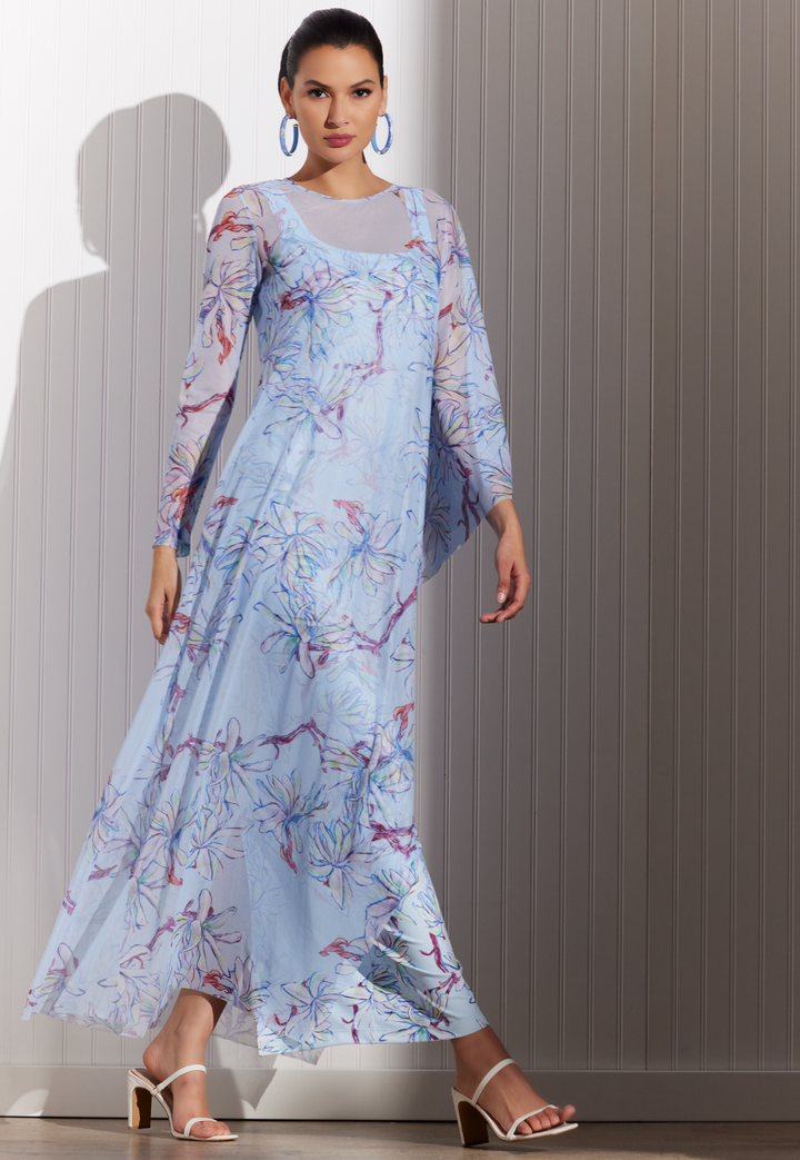 Woman wearing Magnolia sheer poncho over blue floral dress