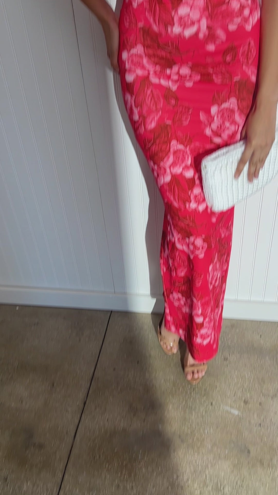 Woman wearing long red floral stretch knit dress by designer Ala von Auersperg for women's luxury travel clothing