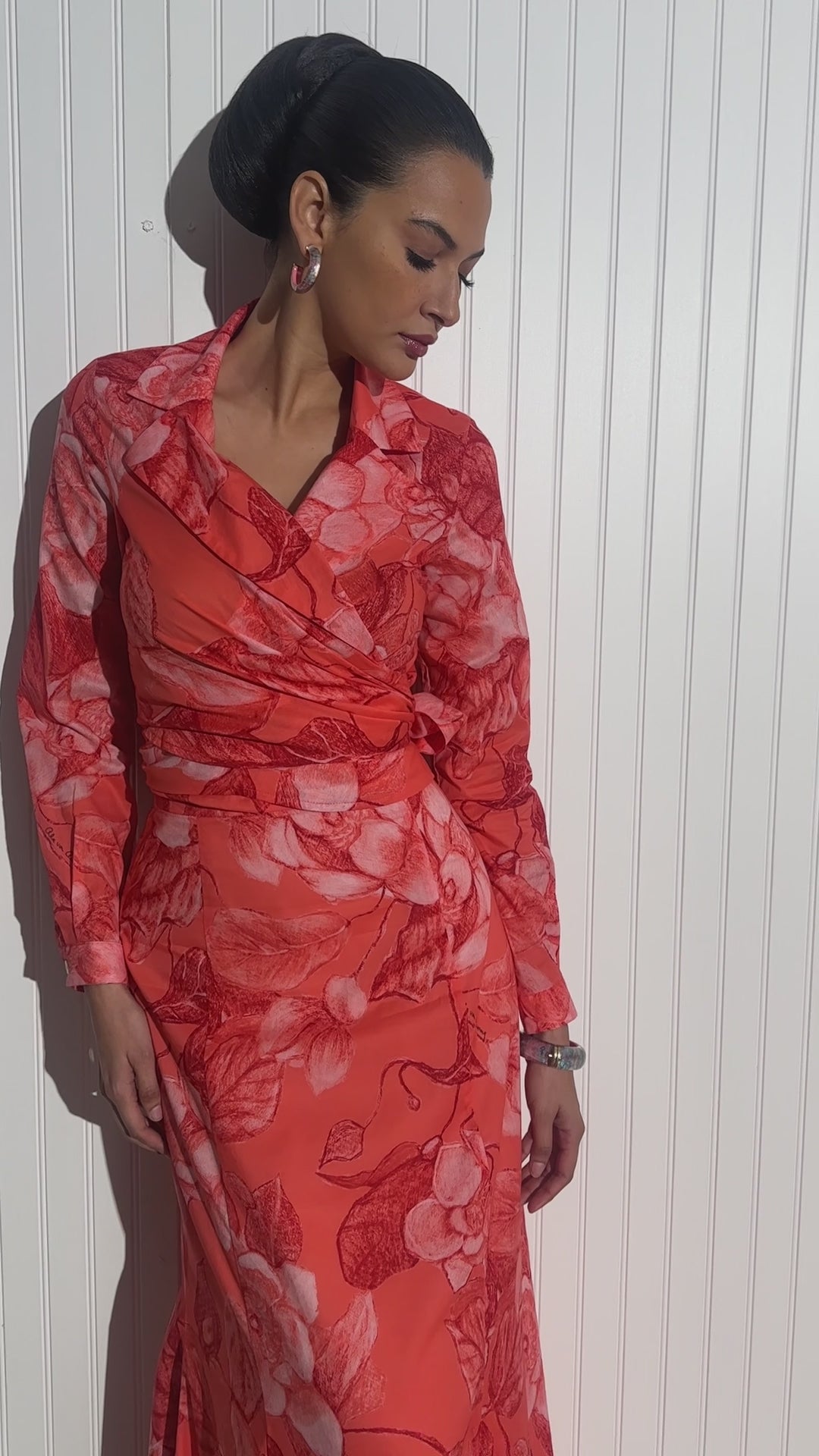 Woman wearing cotton wrap top with matching cotton skirt in a red floral print by designer Ala von Auersperg for womens luxury travel fashion