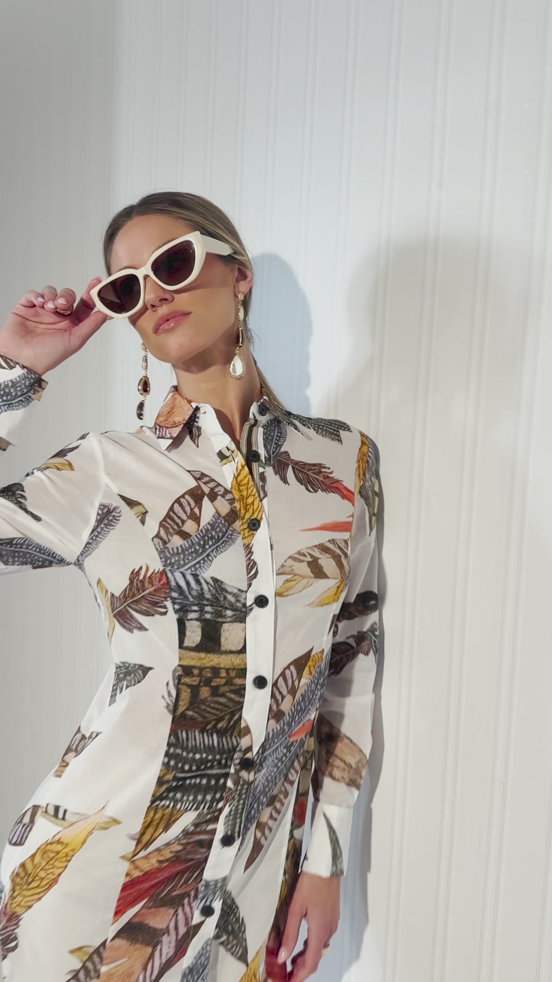 Woman wearing cotton feather printed shirt with khaki cotton pants by Ala von Auersperg