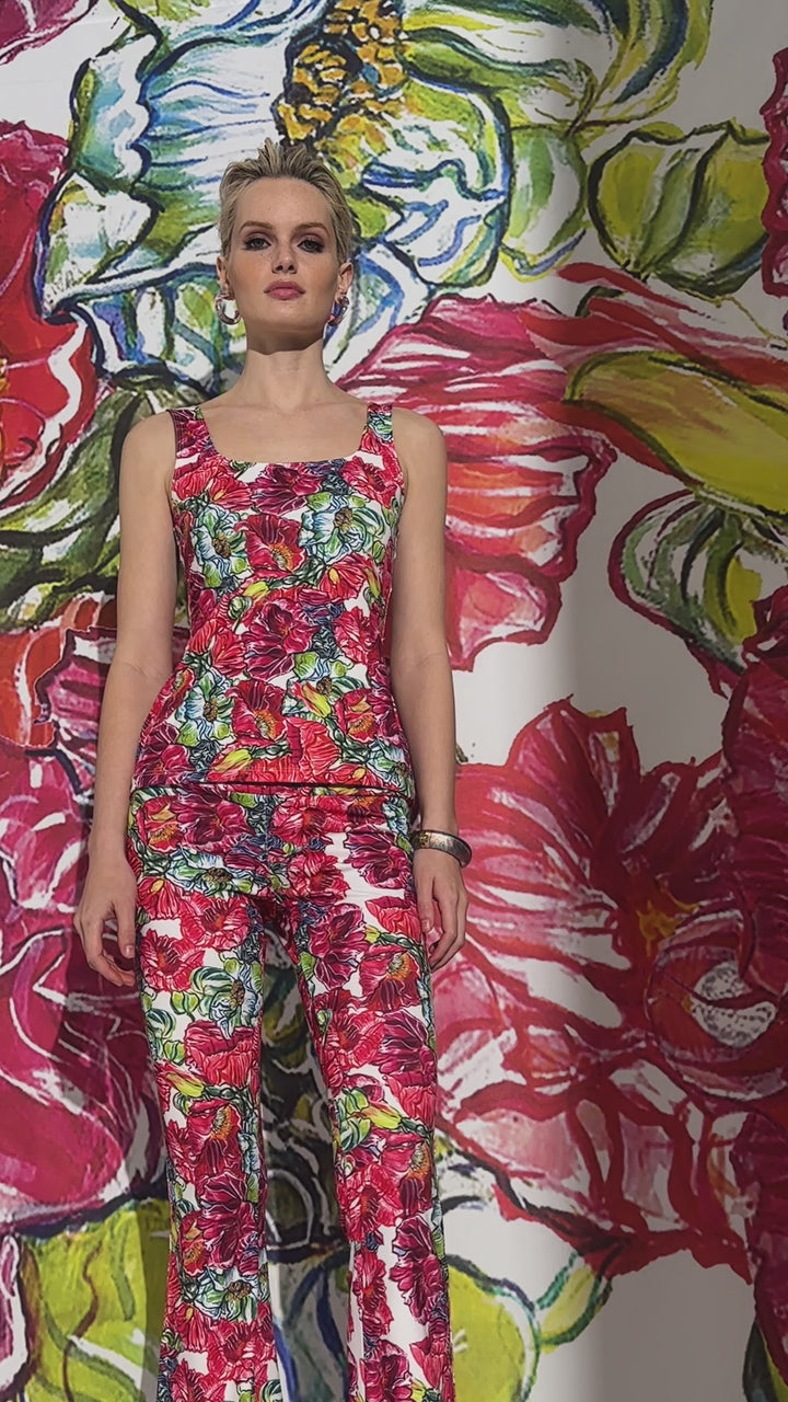 Video of a woman wearing a red floral stretch knit pant with a matching tank top by designer Ala von Auersperg for womens luxury travel clothing