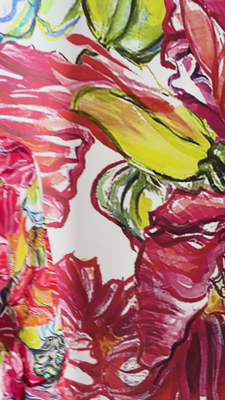 Video of a woman wearing a short cotton day dress in a red floral print by designer Ala von Auersperg for womens luxury travel clothing