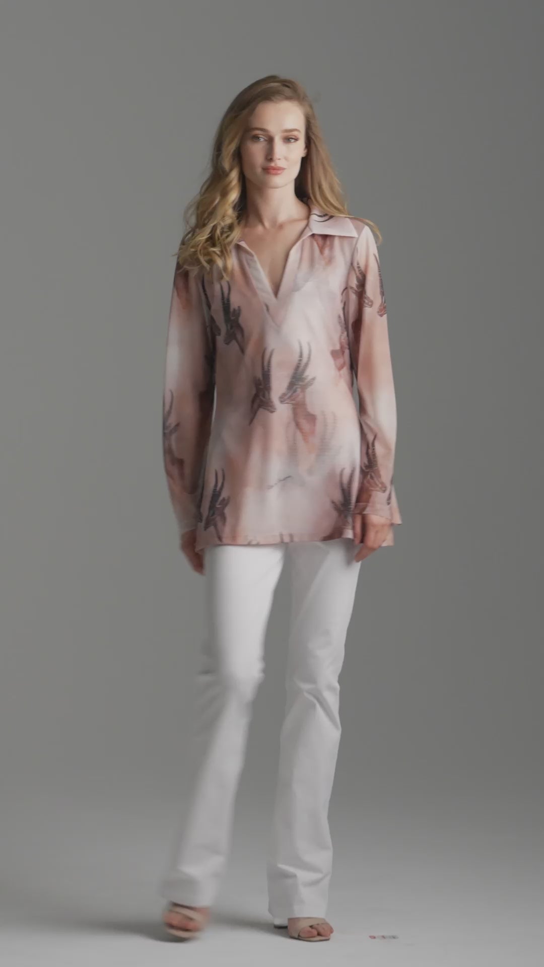 Woman wearing mesh v-neck sweater with organza collar in brown deer print paired with white stretch knit pants by Ala von Auersperg for fall 2023