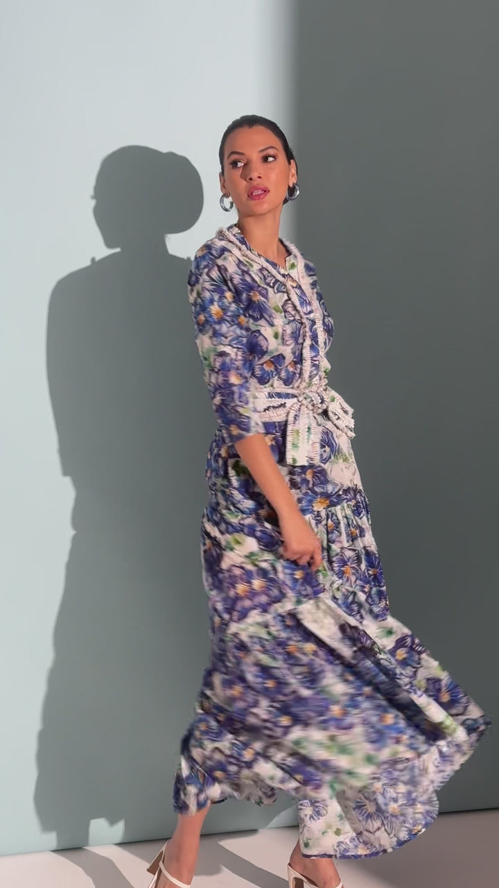 Video of a woman wearing a cotton maxi skirt and a tunic in a matching blue floral print with a belt by designer Ala von Auersperg for womens luxury travel clothing
