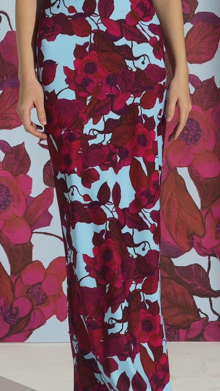 Video of a woman wearing a long stretch knit square neck red floral printed dress by designer Ala von Auersperg for womens luxury travel clothing
