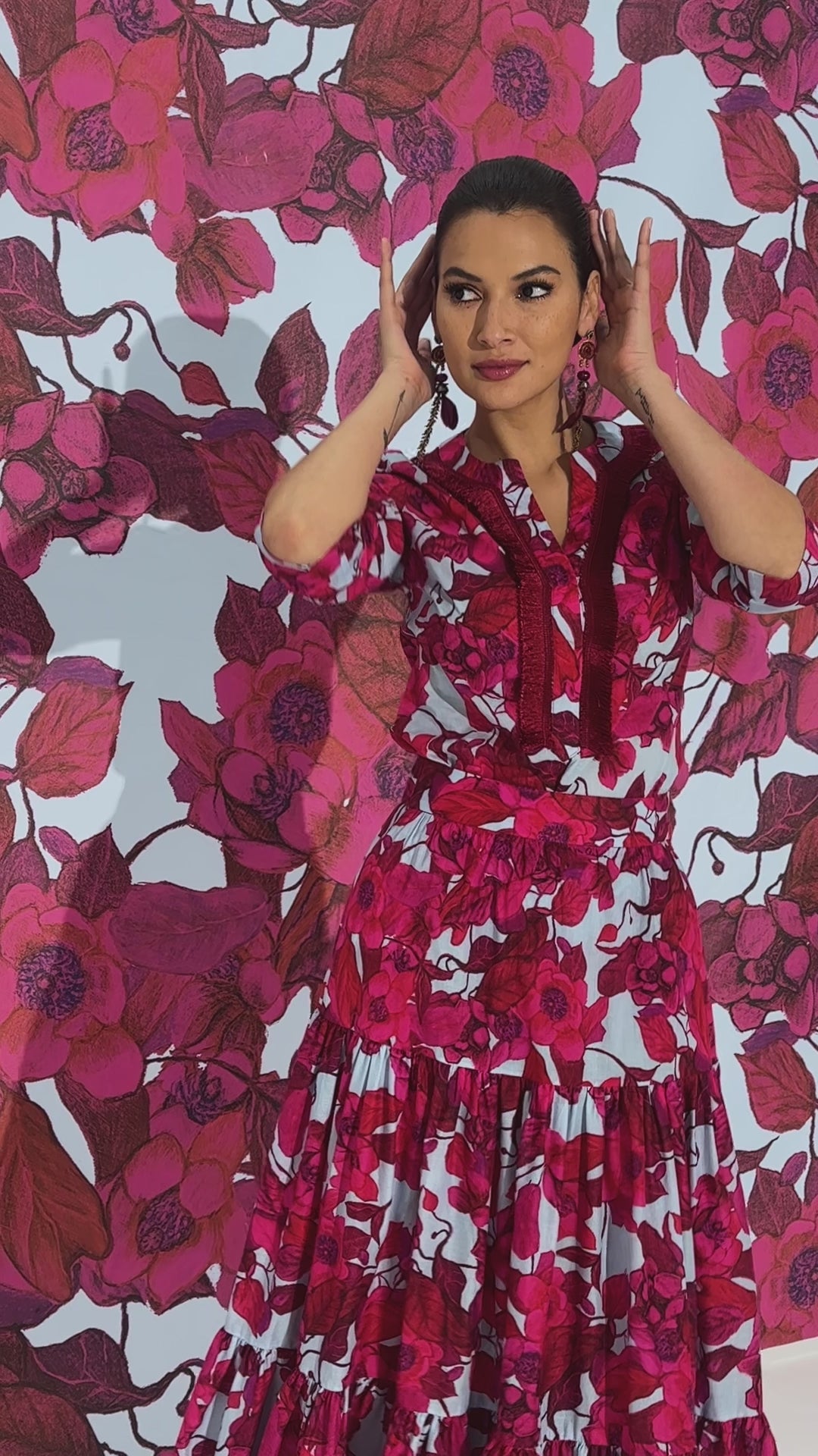 Woman wearing red floral printed cotton tunic with matching maxi skirt by designer Ala von Auersperg for womens luxury travel clothing