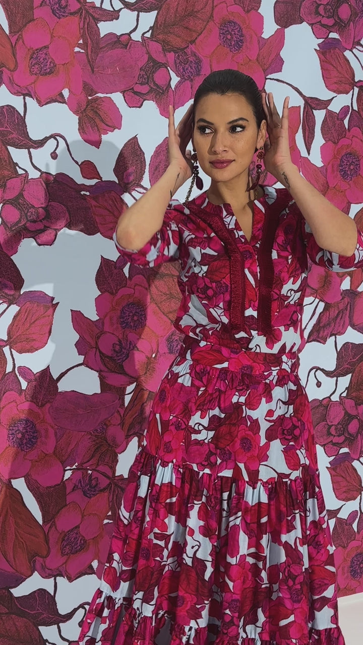 Woman wearing red floral printed cotton tunic with matching maxi skirt by designer Ala von Auersperg for womens luxury travel clothing