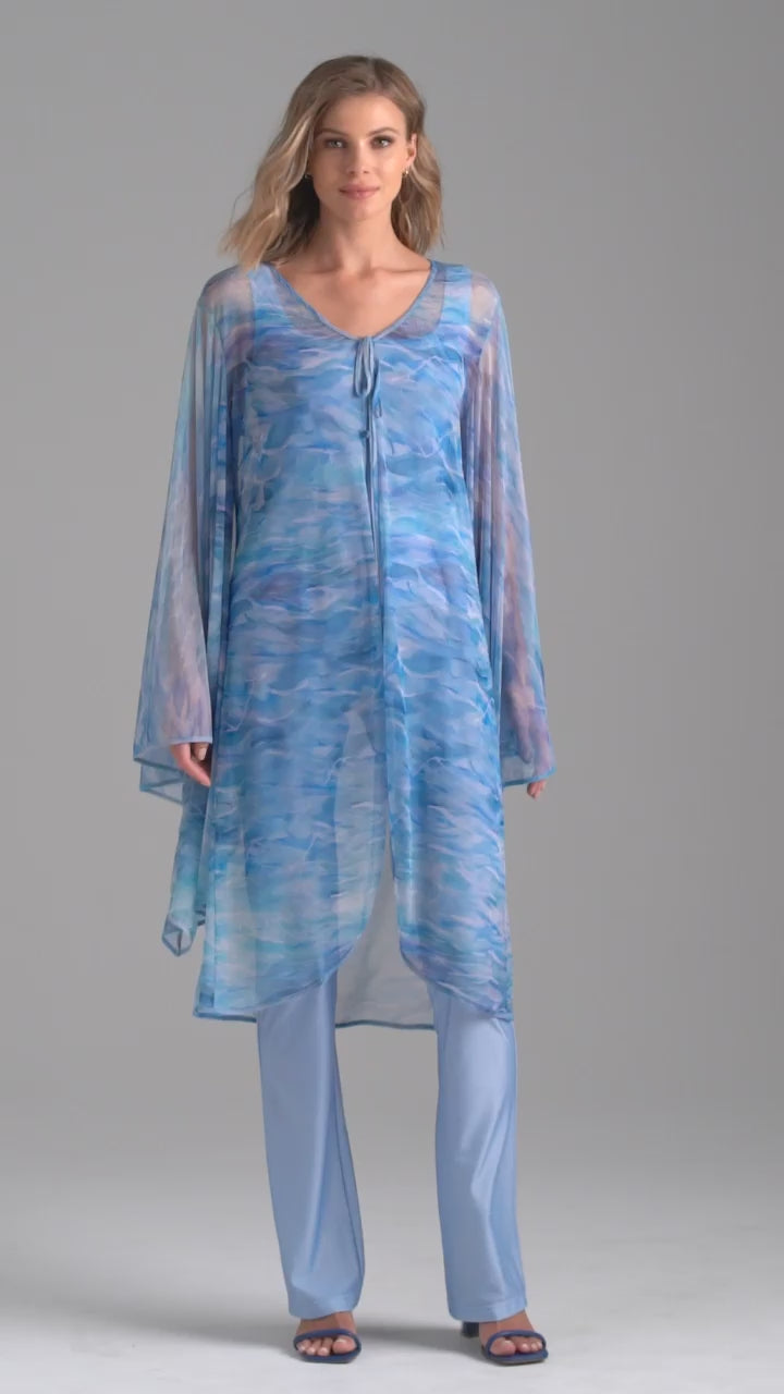 Woman wearing ocean wave printed mesh blue duster with angel sleeves over periwinkle stretch knit tank top and pants by Ala von Auersperg for summer 2023