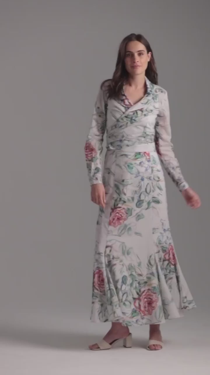 Woman wearing rose printed cotton wrap top with wrap cotton skirt by Ala von Auersperg for summer 2023