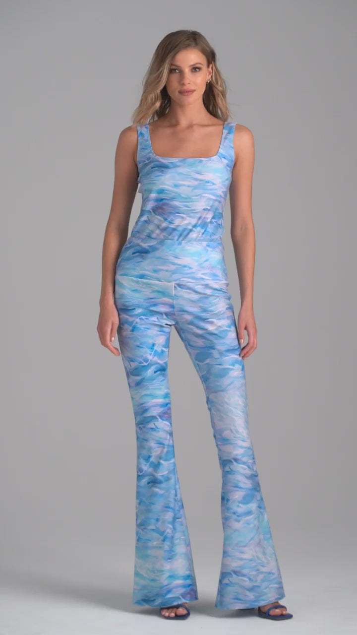 Woman wearing stretch knit ocean printed tank top with white italian cotton stretch knit pants by Ala von Auersperg for summer 2023