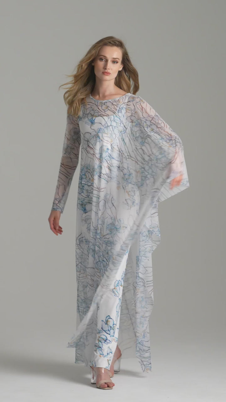 Video of a woman wearing a mesh kaftan bathing suit cover up over a long stretch knit dress by Ala von Auersperg for spring 2024